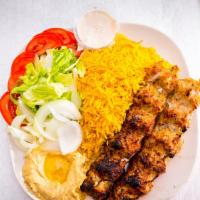 Chicken Kabob Plate · Two grilled chicken kabob skewers served with yellow rice, salad, and hummus.
