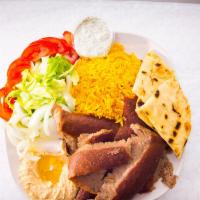Gyros Plate · Beef gyros served with yellow rice, pita bread, tzatziki sauce, and hummus.