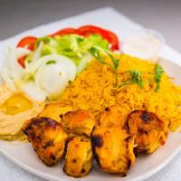 Chicken Tikka Plate · One chicken tikka skewer served with yellow rice, salad, and hummus.