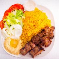 Beef Tikka Plate · One beef tikka skewer served with yellow rice, salad, and hummus.