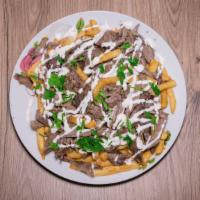 Beef Shawarma Fries · Beef shawarma served on top of fries with our homemade tahini sauce.