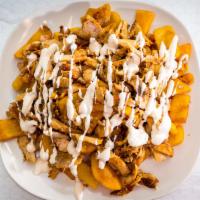 Chicken Shawarma Fries · Chicken shawarma served on top of fries with our homemade garlic sauce.