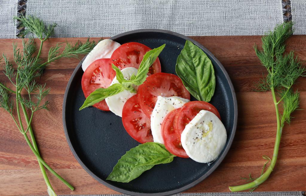 Caprese · Fresh mozzarella, heirloom tomatoes, basil and olive oil.