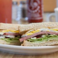 Sandwich · Eggs, choice of ham, bacon or sausage, mayo, lettuce, tomato and onion.