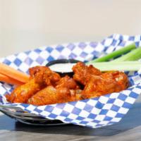 Twice-Cooked Buffalo Wings · Chicken wings baked and then fried to perfection and tossed in buffalo sauce, served with ce...