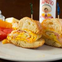 Breakfast Croissant · Scrambled eggs, Protien, and cheese in our Homemade Croissant. Served with Fresh Seasonal Fr...