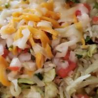 Tostada (Taco Salad) · Served on homemade crunchy flour tortilla, fresh beans, cheese, lettuce, pico de gallo, guac...
