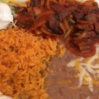 Chile Colorado · Beef cooked with red chile, potatoes, onions, with rice, beans and sour cream.