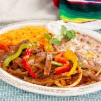 Steak Fajita · Cooked with Mi Casa homemade sauce, vegetables, served with rice, beans and sour cream.