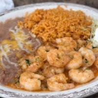 Camarones Al Mojo De Ajo · Succulent shrimp cooked in a garlic wine sauce with rice, beans and sour cream.