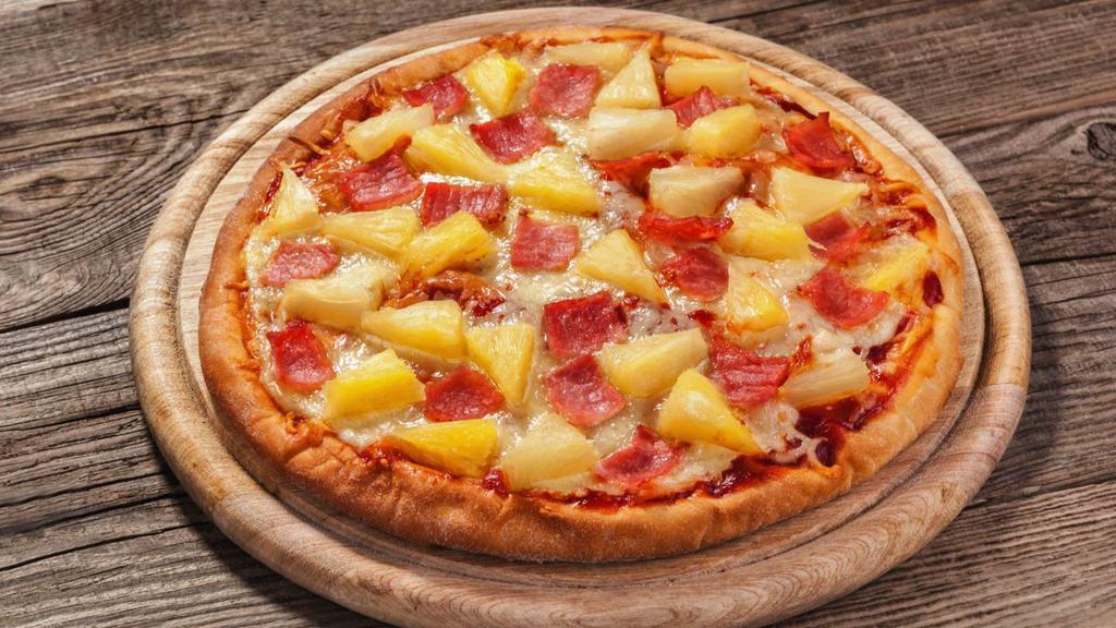 Sweet, Spicy Pineapple Vegan Pizza · A delicious vegan pizza decked with chipotle marinara sauce, vegan cheese, red onion, jalapeño, vegan sausage, pineapples and crushed red pepper.