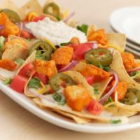 Buffalo Chicken Nachos · Tortilla chips with chicken tossed in our Buffalo Hot sauce, lettuce, tomatoes, red onions, ...