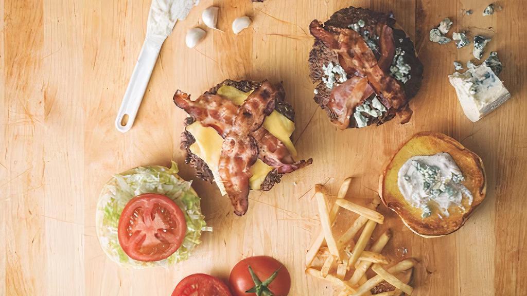 Bacon Cheeseburger · Topped with Applewood-smoked bacon and your choice of cheese. Served on a brioche bun with lettuce, tomato and pickles.