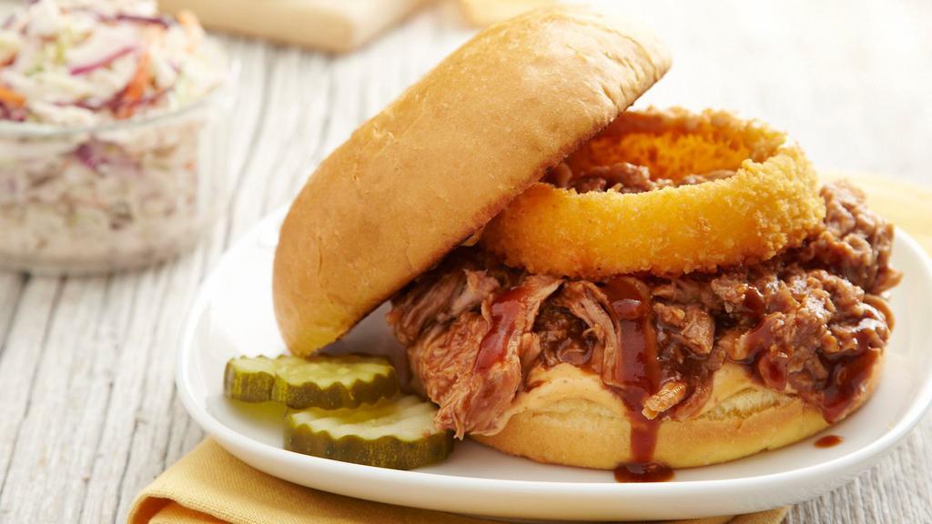 Double Bbq Pork · Tender pulled pork, Sweet BBQ and 'Bama White BBQ sauce, topped with one of our signature onion rings; served on a brioche bun.