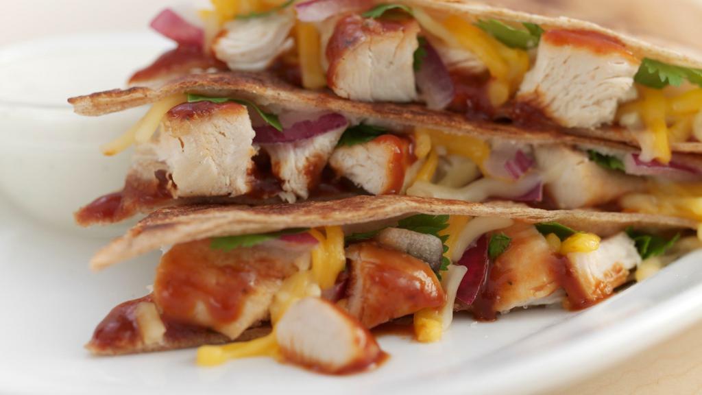 Barbecue Chicken · Grilled chicken, Sweet BBQ sauce, red onions, fresh cilantro and Cheddar Jack in a whole wheat tortilla. Topped with chipotle ranch and minced celery.