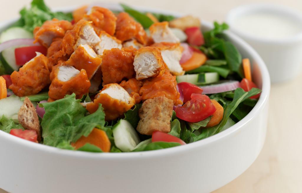 Buffalo Chicken Salad (Fried) · Fried Chicken tossed in Buffalo Medium sauce, assorted greens, shredded carrots, cucumbers, tomatoes, red onions and croutons, ranch dressing.