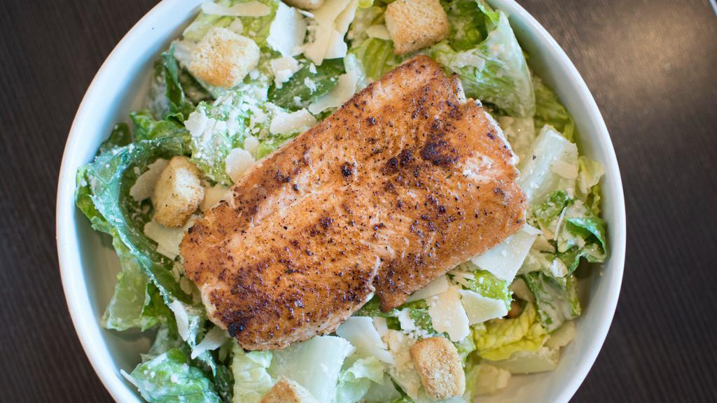 Blackened Salmon Caesar · Blackened salmon, served over romaine leaves, topped with Parmesan and croutons, tossed in Caesar dressing.