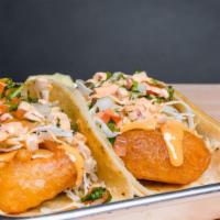 Two Fish Tacos Plate · Two fresh fish tacos with cabbage, pico de gallo and chipotle crema served with rice and bea...