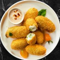 Jalapeno Bug Poppers · (Vegetarian) Fresh jalapenos coated in cream cheese and fried until golden brown.
