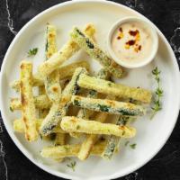 Return Of Zucchini Fries · (Vegetarian) Sliced zucchini breaded and fried until golden brown. Served with your choice o...