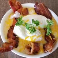 Cheesy Grits Bowl · Delicious slow-cooked cheesy grits  bowl served with crispy bacon, 2 poached eggs and toast.