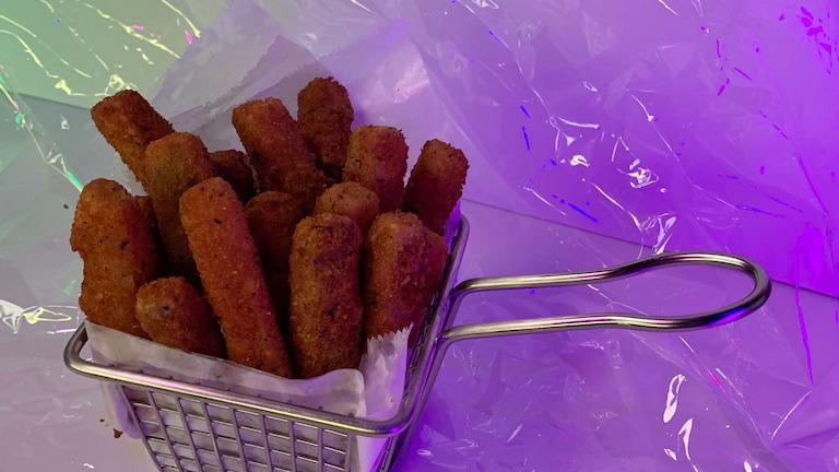 Breaded Zucchini Fries · Basket of zucchini fries served with aioli sauce.
