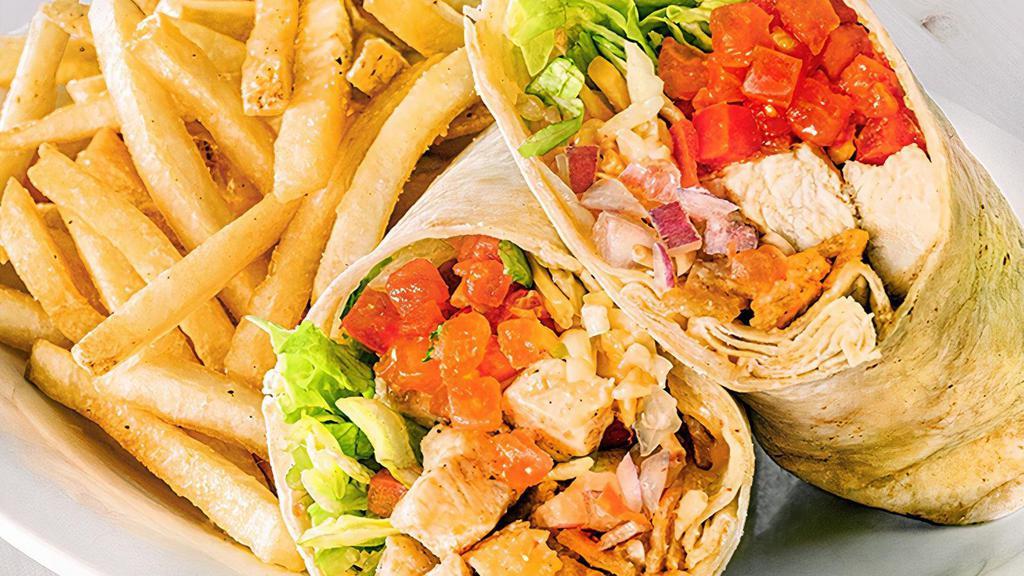 Cancun Chicken Wrap · Grilled or crispy diced chicken breast, shredded cheddar jack cheese, lettuce, tomatoes and crispy tortilla strips tossed in a Sriracha ranch dressing and wrapped in a flour tortilla.  Served with a side item. (1260/1410 cal)