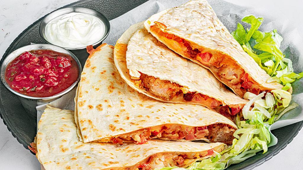 Shrimp Blt Quesadilla · A fusion of bold flavors, this grilled flour tortilla is chock full of fried shrimp, crumbled bacon, diced tomatoes and melty jack and cheddar cheese with sriracha ranch dressing. Served with a side of cool sour cream and salsa for dipping. (1340 cal.)
