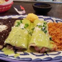 Crab & Shrimp Enchiladas · Crab and shrimp enchiladas top with butter cream sauce and cheese, with rice and beans.