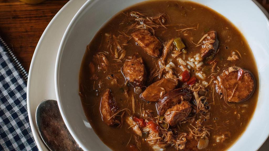 Gumbo · BJ fine gumbo - one quart of shredded chicken and crabmeat bisque with chicken andouille sausage, shrimp and crab leg with 16 oz white rice.
