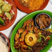 Ultimate Fajitas · Imagine our famous marinated chicken, beef and shrimp fajitas then add our incredible carnit...
