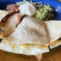 Quesadillas · The Mexican version of a grilled cheese sandwich. A grilled flour tortilla smothered with me...