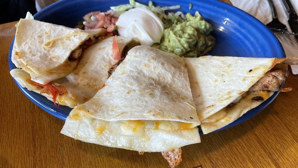 Quesadillas · The Mexican version of a grilled cheese sandwich. A grilled flour tortilla smothered with melted cheese. Served with sour cream.