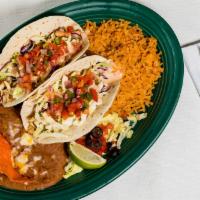Fish Tacos · Two tacos with pan seared tilapia fillets on flour tortillas with our home-made coleslaw, pi...