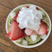 Green Tea · Green tea base with mochi and strawberry toppings.