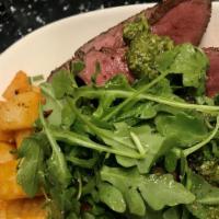 Flatiron Steak · Grilled Flatiron Steak drizzled in homemade pesto, served with a side of cripsy potatoes and...