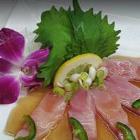 Yellowtail Carpaccio · Sashimi Yellowtail, ponzu, scallion, jalapeno, red onion, siracha, garlic crisp