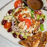 Asian Harvest Salad · Mixed greens topped with grilled chicken breast, sliced tomatoes, red grapes, red onions, nu...