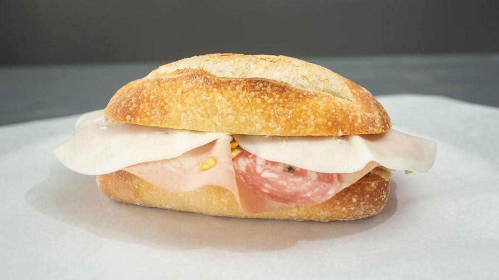 The Italian Sandwich · Genoa salami, soppressata, mortadella, Italian ham, provolone, tomatoes, iceberg.