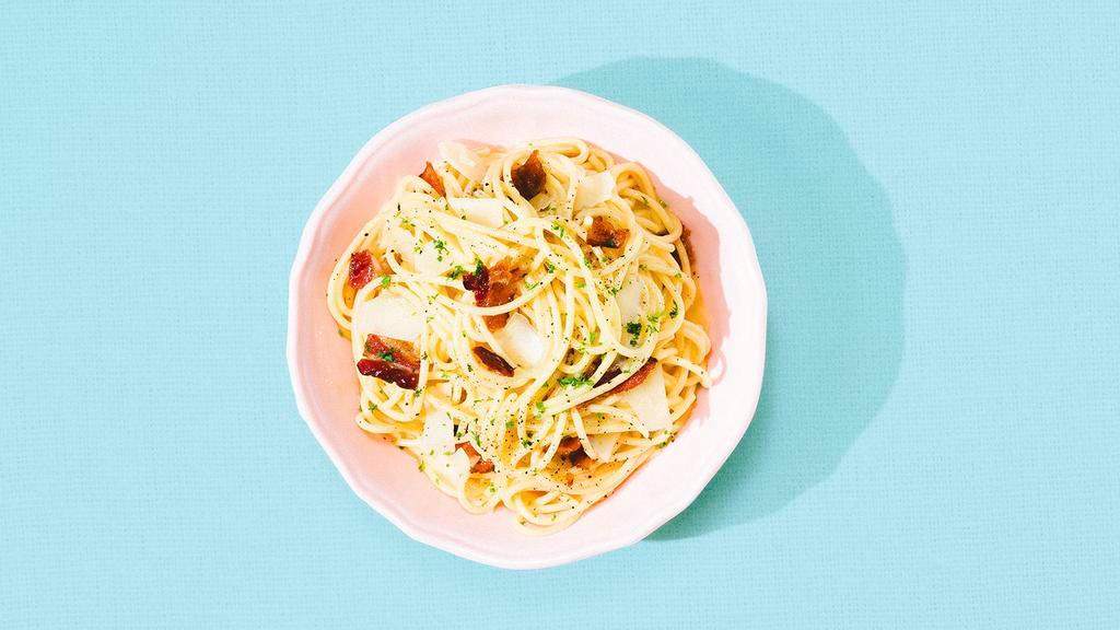 Pasta Carbonara · Spaghetti in a classic Carbonara sauce of egg yolks and cheese mixed with crispy bacon and topped with fresh Parmesan cheese.
