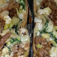 Burrito · Your choice of asada, pastor, chicken or shredded beef, rice and beans and cabbage, onion, c...