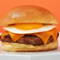 Breakfast Burger · Ground angus beef patty, fried egg, cheese, caramelized onions, and aioli.