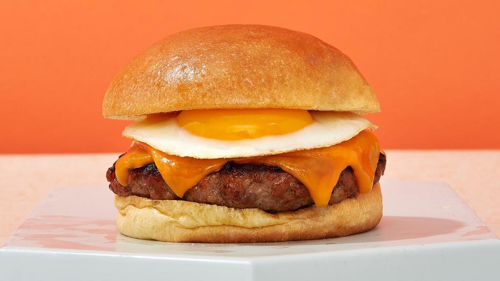 Breakfast Burger · Ground angus beef patty, fried egg, cheese, caramelized onions, and aioli.