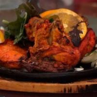 Tandoori Chicken Tikka · Chicken pieces marinated in a blend of special spices & yogurt baked in clay oven