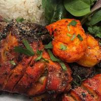 Mixed Grill · Mix of tandoori chicken tikka, lamb seekh kebab, chicken drumsticks and tandoori shrimp serv...