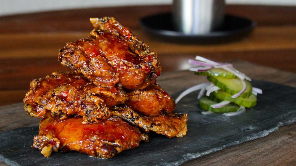 Boneless Thai Chili Wings · Served with cucumber salad.