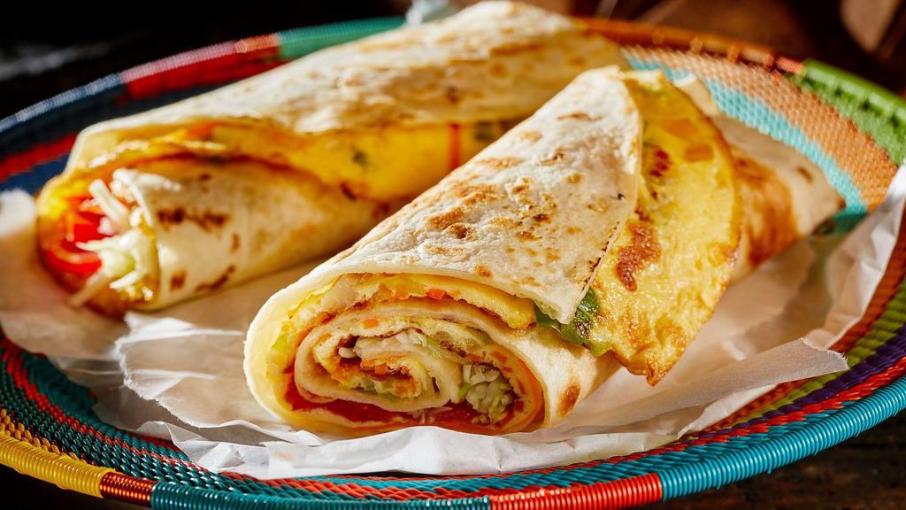 Egg On A Roll · Fresh eggs marinated with indian spices stuffed inside fresh Indian Bread.