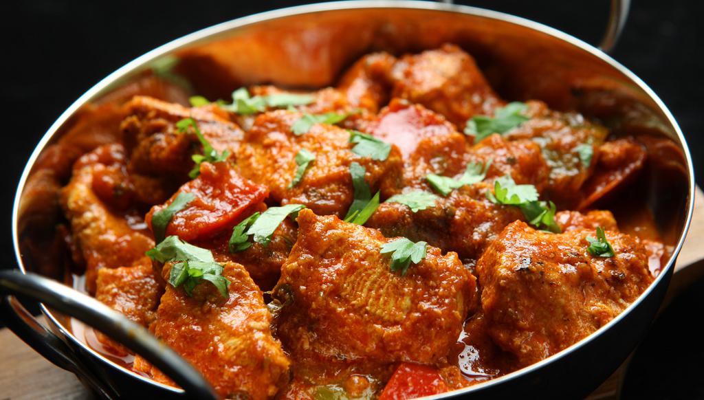 The Chicken Karahi · Spicy & flavorful dish made with chicken, onions, tomatoes, ginger, garlic & fresh ground spices.