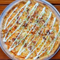 Americana Buffalo Pie  · Breaded chicken, celery, mozzarella and hot sauce Drizzled with ranch dressing.