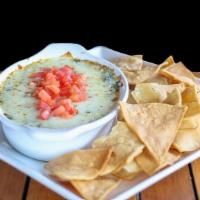 Spinach And Artichoke Dip · Served with tortilla chips.
